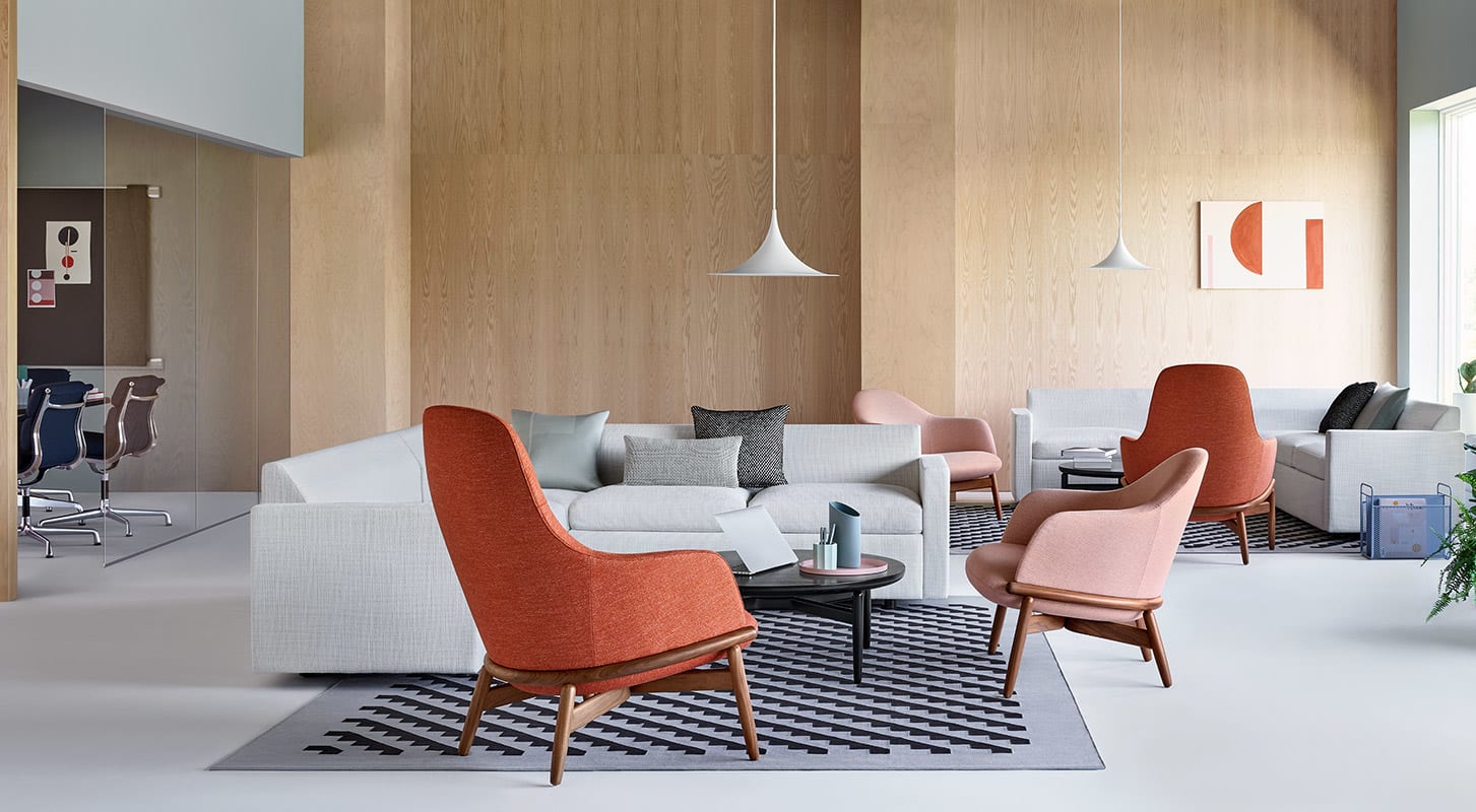 A modern living room featuring sleek gray furniture and vibrant orange chairs, creating a stylish and inviting atmosphere.